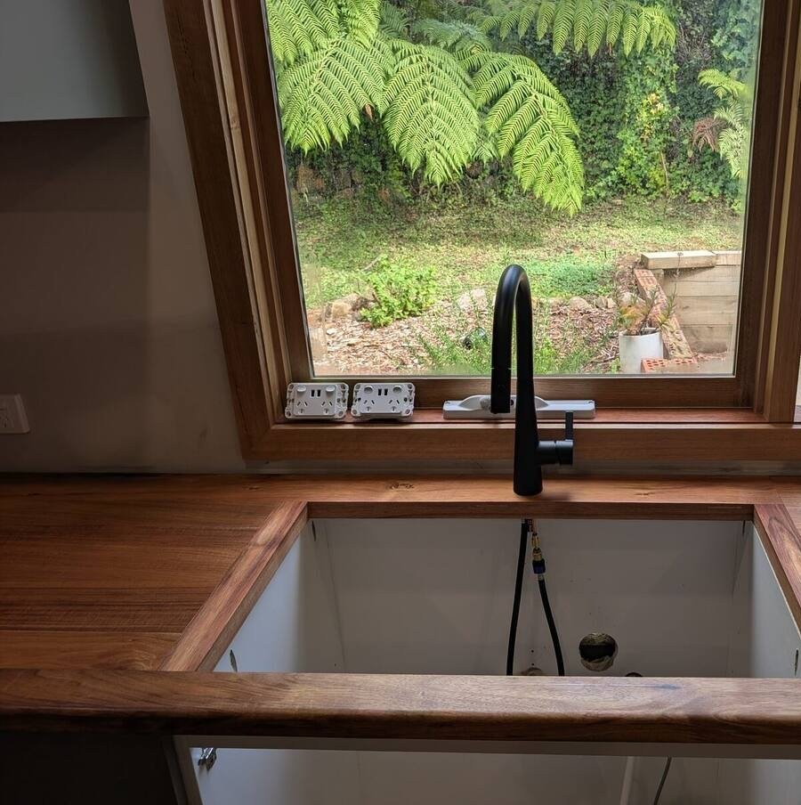Black undermount sink set into reclaimed Blackwood kitchen benchtop